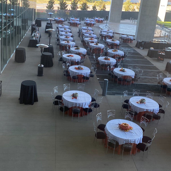 aerial view of high and round tables on covered patio of a venue