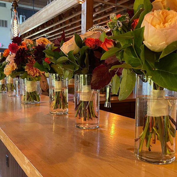 orange, purple, and green floral arrangement at a wedding