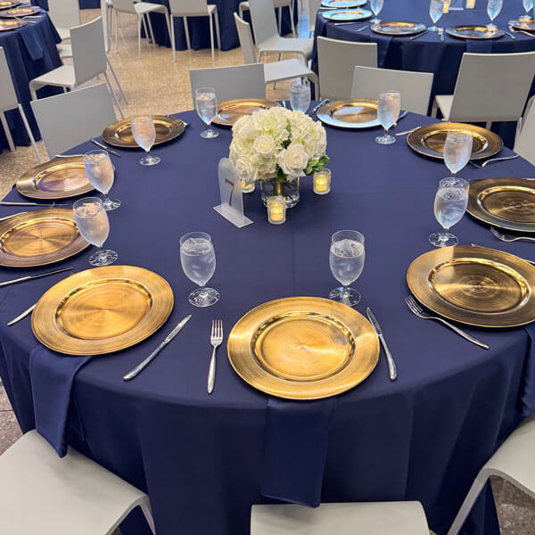 navy blue linen and gold tableware for luxury event