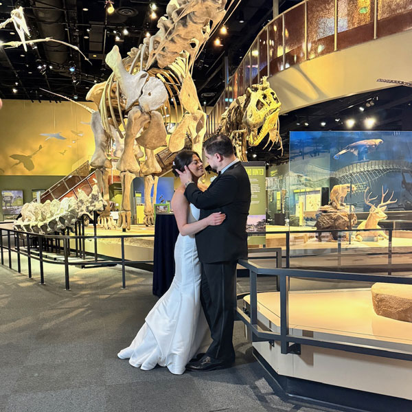 bride and groom embracing at a wedding inside a museum planned by Total Events DFW