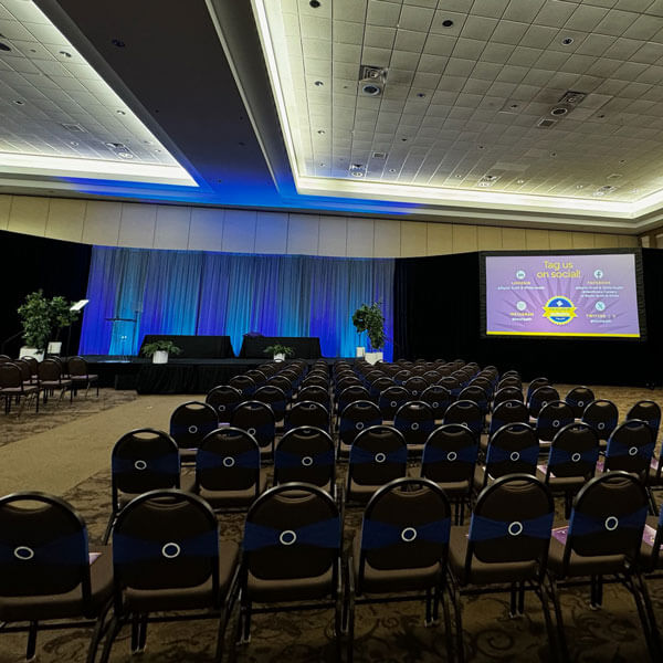 lots of seating in a large conference room for a corporate event