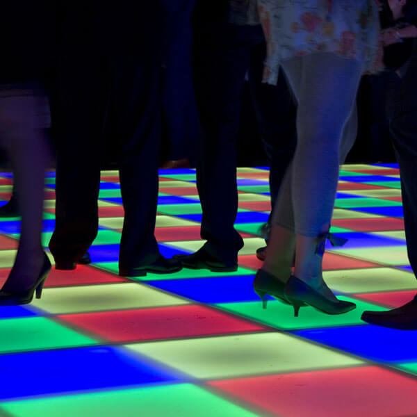 modular LED dance floor lights up dark room at an event