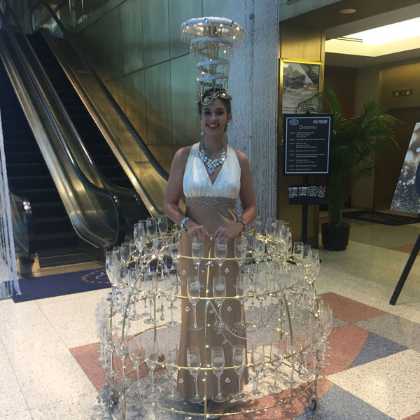 gorgeous champagne skirt model serving guests champagne at en event